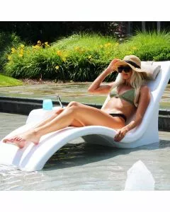 Lady lounging on the In-Pool Lounger with connecting table