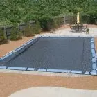 Lifestyle shot of Hi-Tech Micro-Mesh cover on inground, rectangle pool