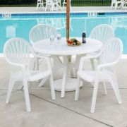 View of Grosfillex 46 in Round Acadia Dining Table and 4 Pacific Fanback Armchairs in French Taupe poolside