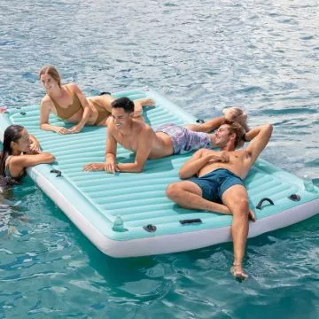 People floating on the Intex Floating Water Lounge Mat
