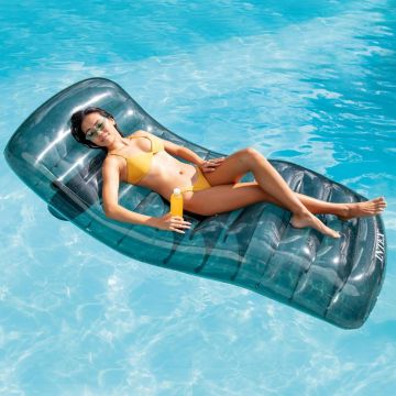 Woman floating on the Intex Cool Grey Lounge in crystal clear water