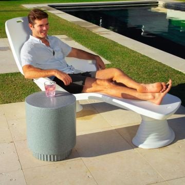 Man lounging poolside in a white Shayz lounge with 8 in risers
