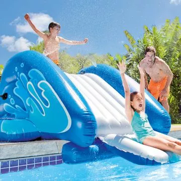 Kids and adult enjoying the Intex Pool Splash Water Slide with water splashes on a sunny day,