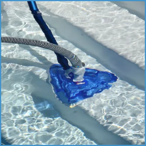 Using a pool vacuum to clean the steps during pool opening.